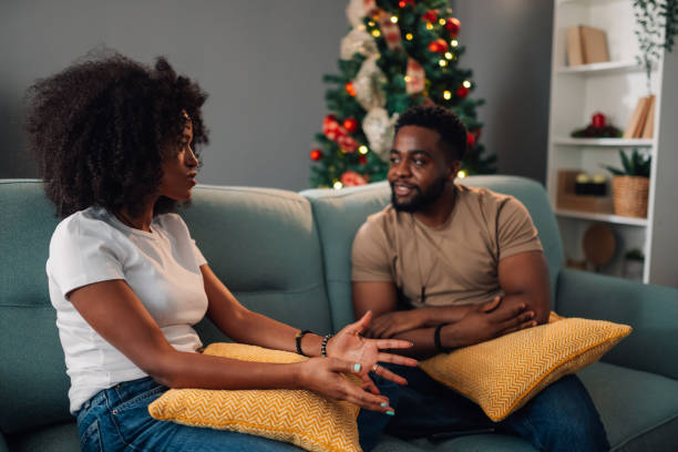 istock Engaging diverse couple conversation at home beside Christmas decor 2179002562