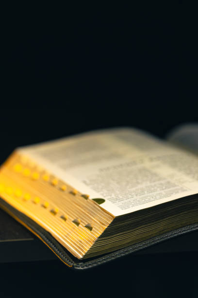 istock Open Bible on a black background. Religion concept. 2179003005