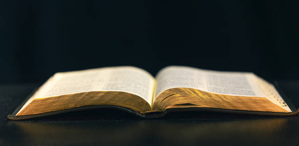 istock Open Bible on a black background. Religion concept. 2179003007