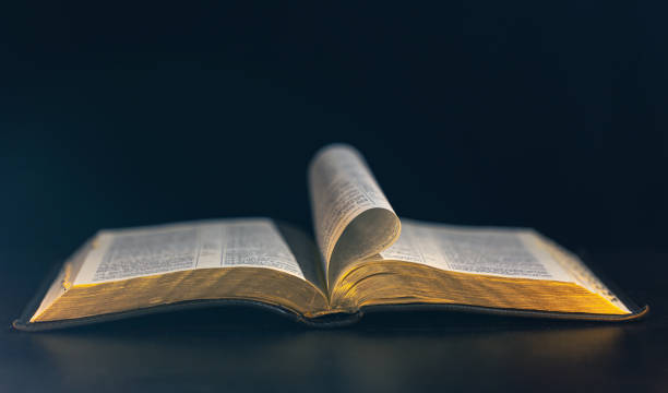 istock Open Bible on a black background. Religion concept. 2179003021