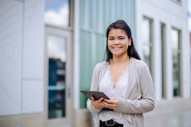 istock Asian Entrepreneur With Digital Tablet Standing Outside Office Building 2179004431