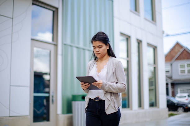 istock Asian Entrepreneur With Digital Tablet Standing Outside Office Building 2179004436