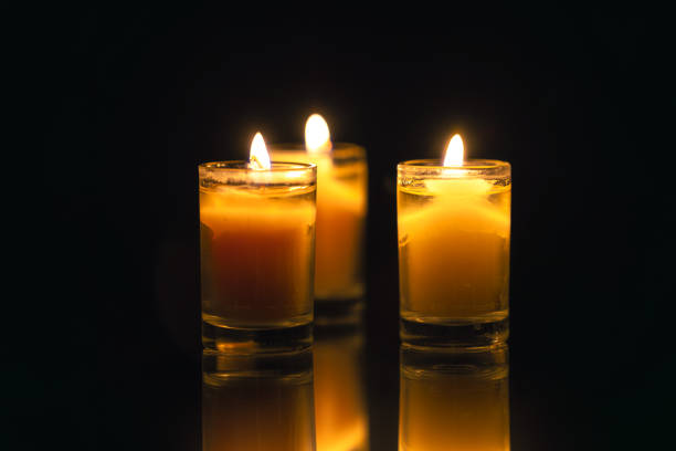 Burning candle on black background with backlight. . Memorial Day. High quality photo