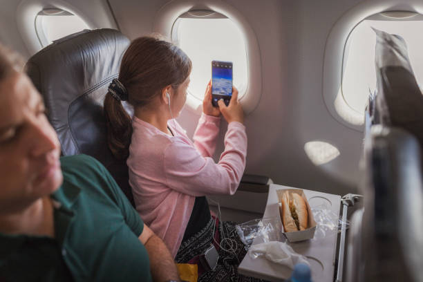 istock Girl taking photos through the airplane windows 2179023529
