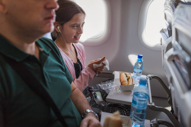 istock Girl wiping hands before having a snack at a plane 2179023539