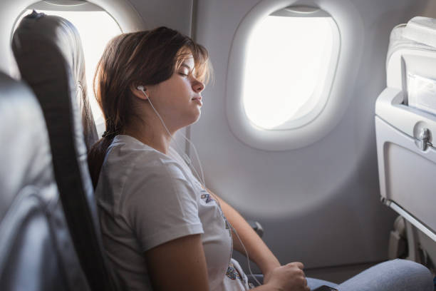 istock Girl sleeping at an airplane 2179023611