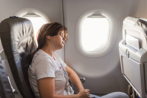 istock Girl sleeping at an airplane 2179023618