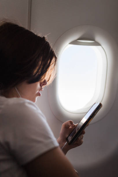 istock Close-up of a girl using phone on a plane 2179023682