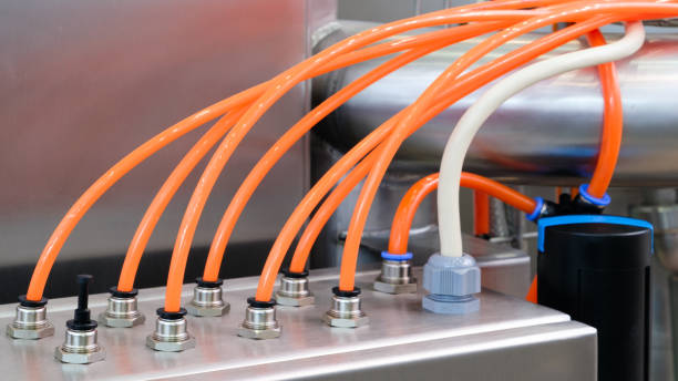 istock Pneumatic industrial conveyor machine with orange plastic tubes, industrial concept background 2179025318