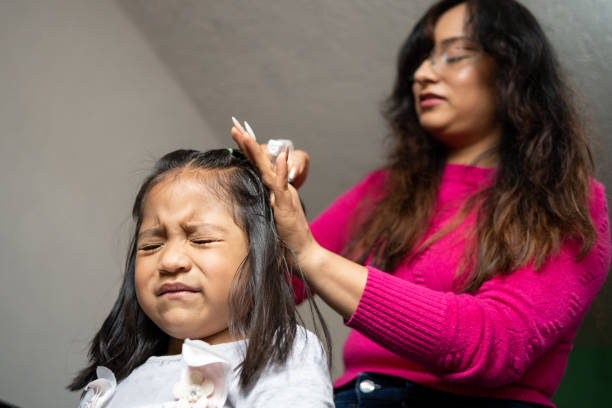 istock Mexican girl angry while her mother combs her hair 2179027278