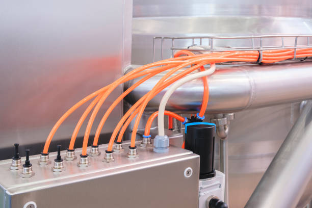 istock Pneumatic industrial conveyor machine with orange plastic tubes, industrial concept background 2179027830