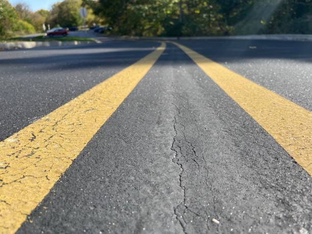 istock Low Angle View of Road with Yellow Center Lines 2179028914