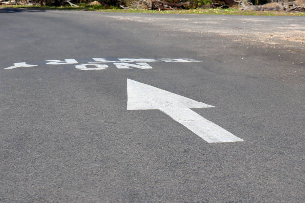painted arrow and no entry signage on road