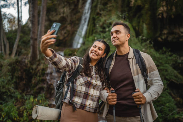 istock hiker couple backpackers take a self portrait around waterfall 2179044016