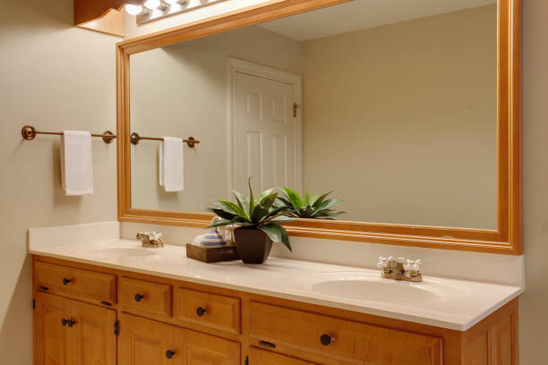 istock Warm Wooden Bathroom With Large Mirror And Lighting. 2179045894