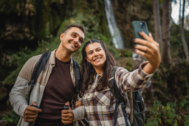 istock hiker couple backpackers take a self portrait around waterfall 2179047192