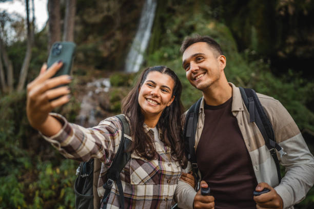 istock hiker couple backpackers take a self portrait around waterfall 2179047318