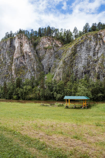 istock Imagine a tranquil scene of a beautiful grassy field under a clear sky, fluffy clouds, a small hut, and a mountain backdrop, creating a breathtaking natural landscape in the highlands 2179056139