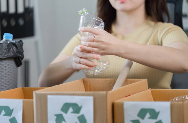 istock Young Woman Sorting Recyclable Trash at Home for Environmental Conservation and Sustainability 2179060907