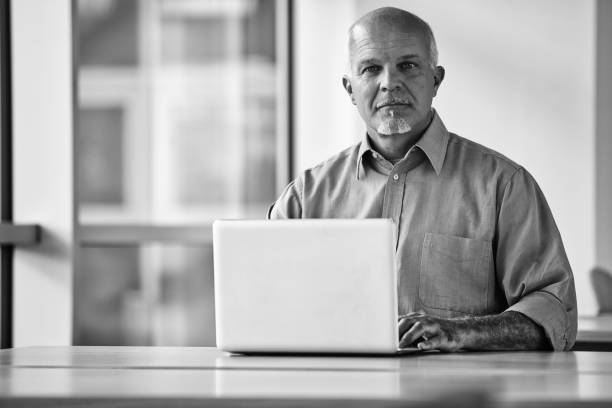 istock Mature businessman working on laptop in modern office 2179071728
