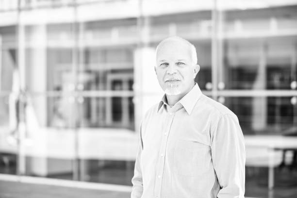istock Senior manager posing and smiling outside office building 2179071970