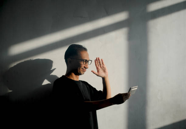 istock Reflection of a man is waving in video call. 2179076555