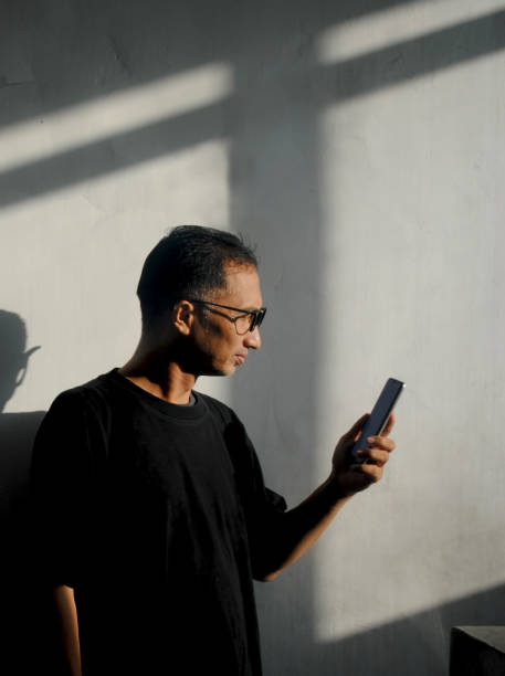 istock Reflection of a man texting a message in smartphone. 2179076570