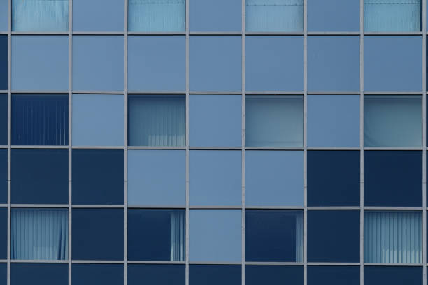 istock blue glass building facade with grid windows 2179080484