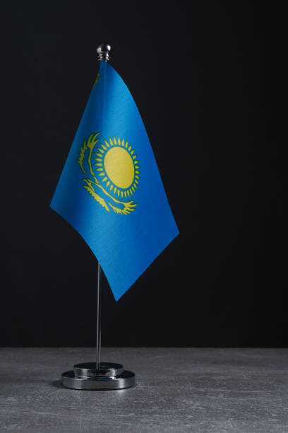 istock Flag Republic Kazakhstan on small flagpole on dark background. 2179080519