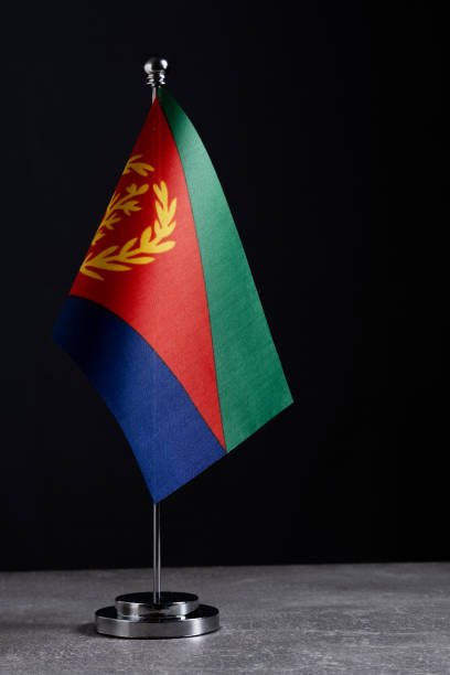 istock Eritrea table flag on metal stand against dark background. 2179080548