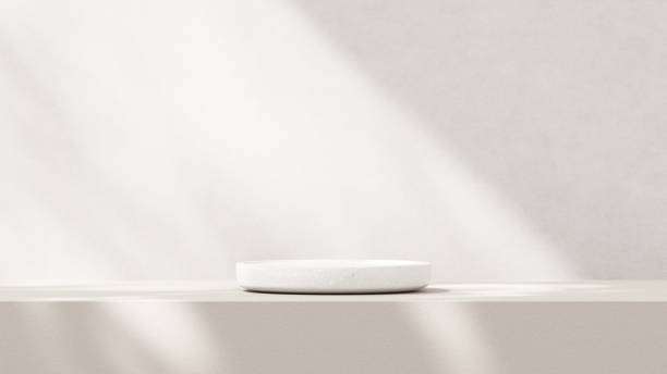 istock Minimalistic, simple, and light background for product presentation. Streaming sunlight casts soft shadows from a window onto a white-gray wall and floor, creating a clean and elegant atmosphere. 2179082681