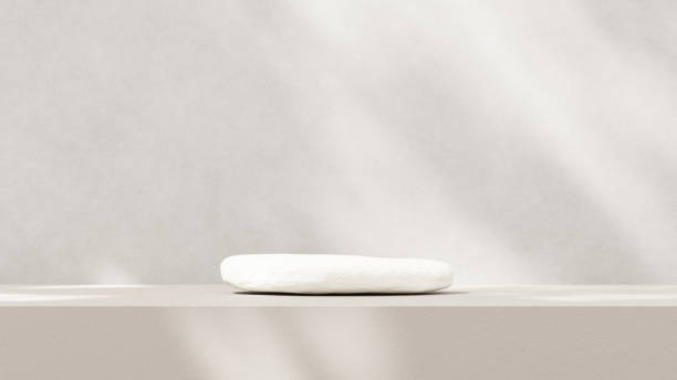 istock Minimalistic, simple, and light background for product presentation. Streaming sunlight casts soft shadows from a window onto a white-gray wall and floor, creating a clean and elegant atmosphere. 2179082685