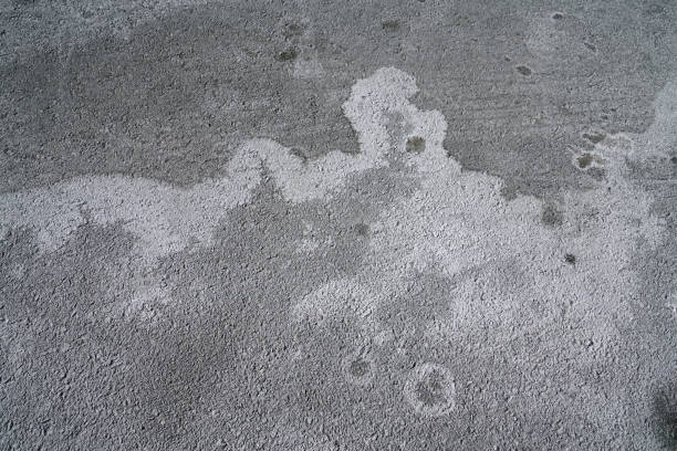 istock winter ice melting salt on the ground, pattern as background 2179086985