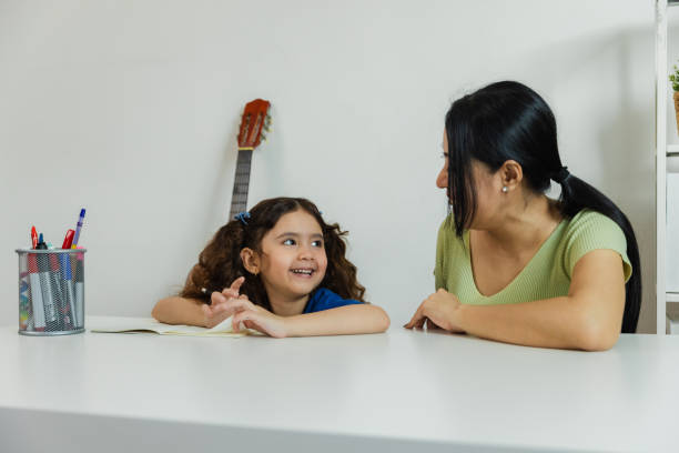 istock A mother and daughter enjoy quality time while studying at a white table in a cozy room filled with creativity and learning moments 2179087461