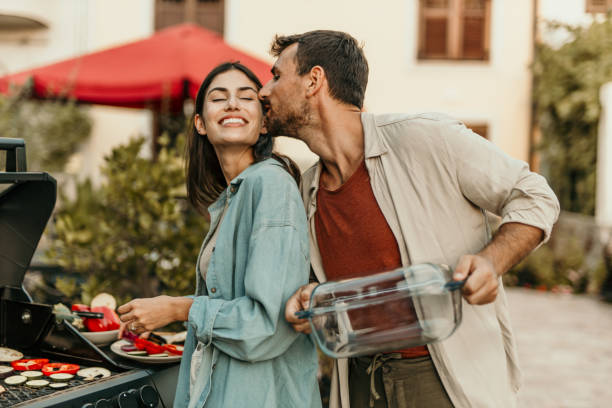 istock Young couple making barbecue for dinner party at their backyard 2179100162