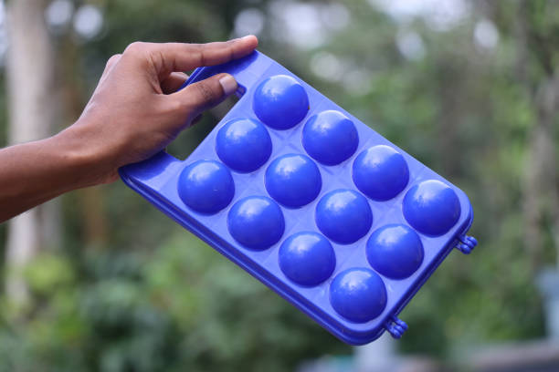 istock Plastic box for eggs to keep a dozen of eggs held in the hand. Egg storing plastic tray 2179101192