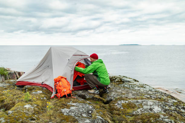 istock Mid adult man arranging tent 2179101576