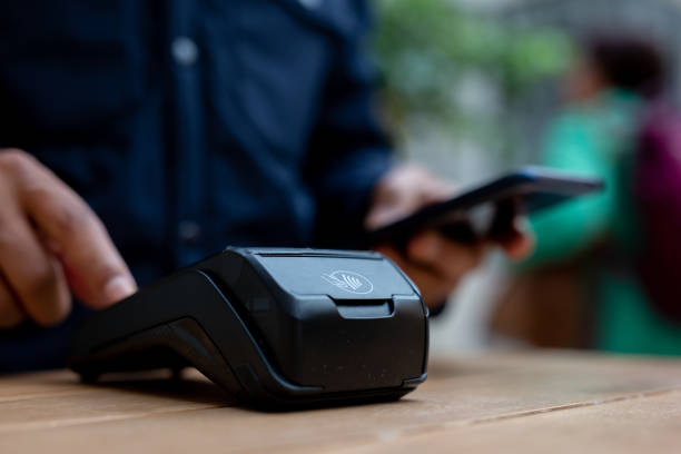 istock Customer making nfc payment with smartphone in a shop 2179105938