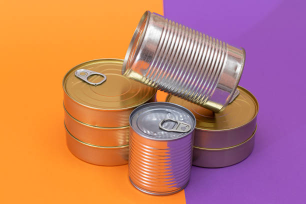 istock A Group of Stacked Tin Cans with Blank Edges on Split Orange and Violet Background 2179106046