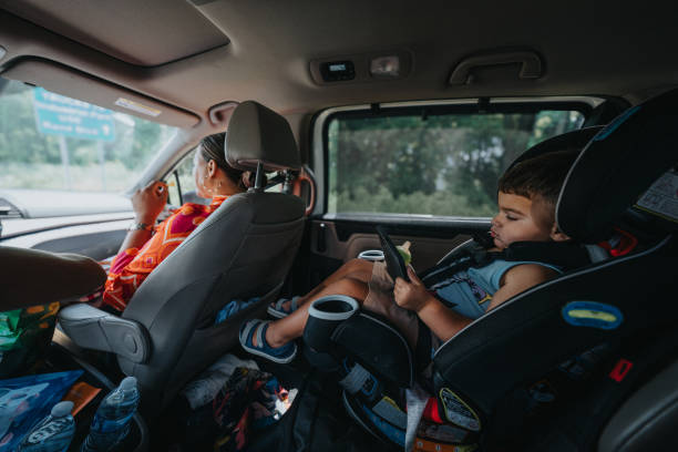 istock Toddler boy playing on smart phone while in the car 2179107587