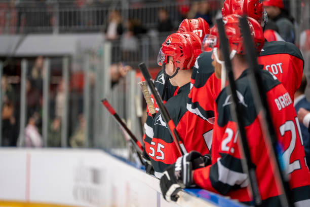 Focused on the Game: Hockey Players Watching from the Bench