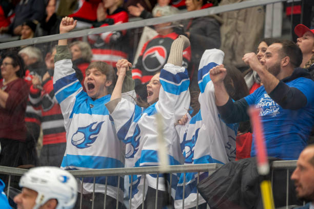 istock Enthusiastic Hockey Fans Cheering for Their Team 2179109037