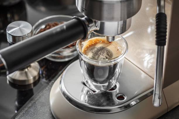 istock Automatic coffee machine. Pouring coffee into the coffee cup closeup. 2179110419