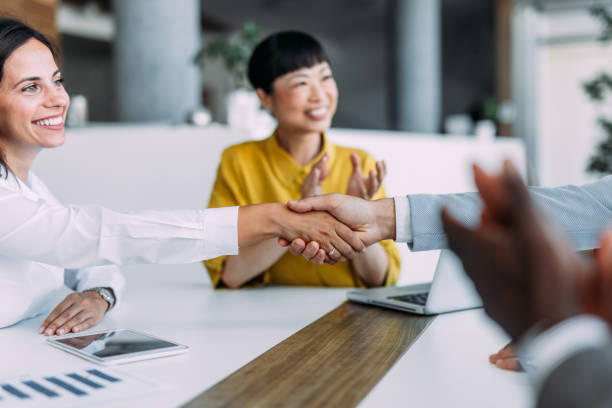 istock Businesspeople shaking hands across the table. 2179110782