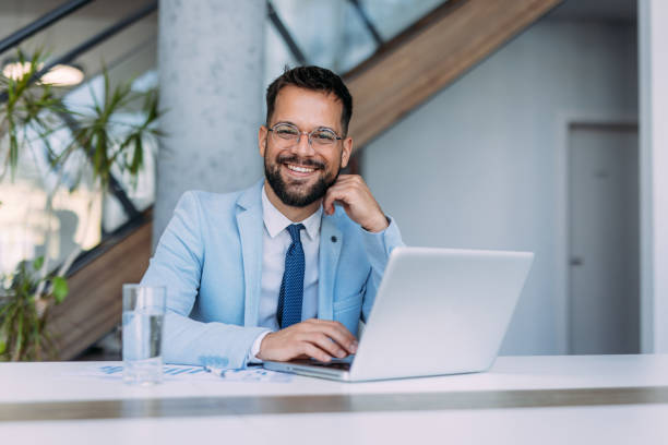 istock Successful businessman in modern office working on laptop. 2179110855