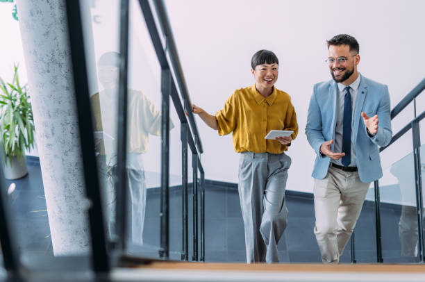istock Business colleagues talking on stairs in the office. 2179110862