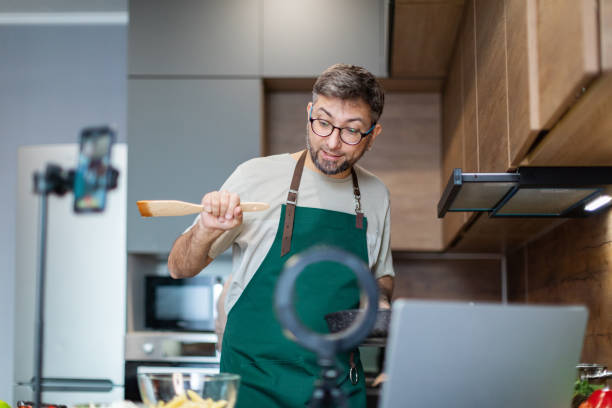 istock Mid adult man cooking and streaming 2179114203