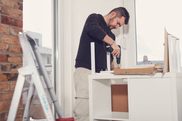 istock Man working and assembling furniture in a new apartment. 2179114268