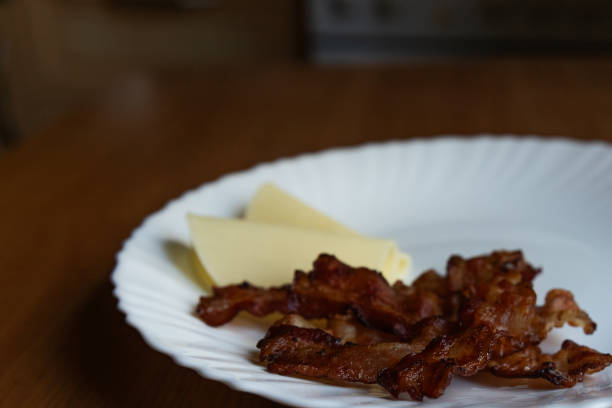 istock a bunch of fried bacon and some cheese on a plate 2179115067