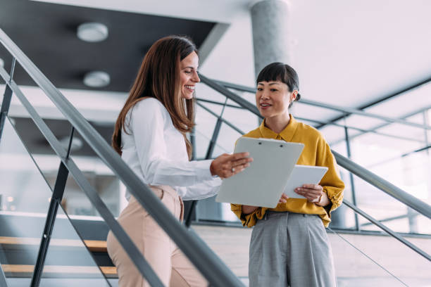 istock Business colleagues talking on stairs in the office. 2179126103